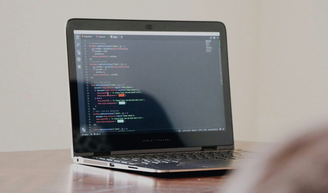developer coding on laptop